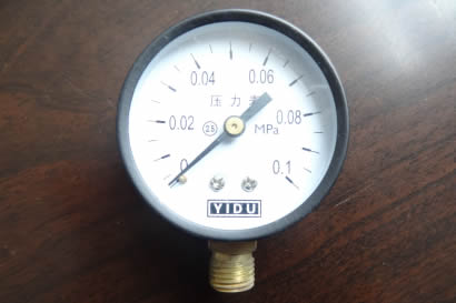 A pressure gauge is on the table.